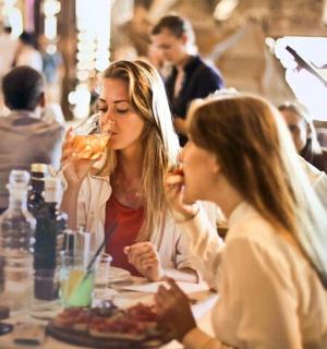 两个女人坐在桌边吃饭