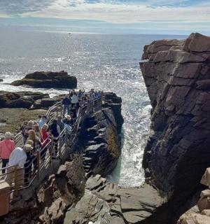 一群人站在海边的悬崖上