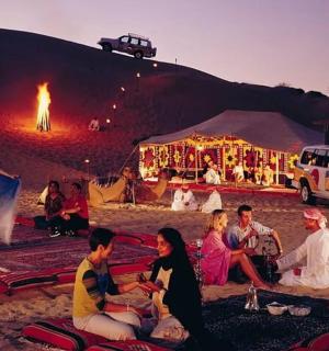 a group of people sitting in front of a tent