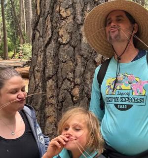 a man and a woman standing next to a tree