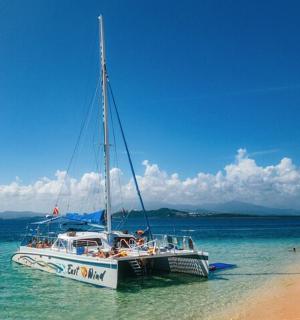 a boat sitting on the beach next to a beach