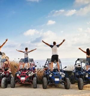 a group of people standing on four four wheelers
