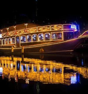 a boat with lights on the water at night