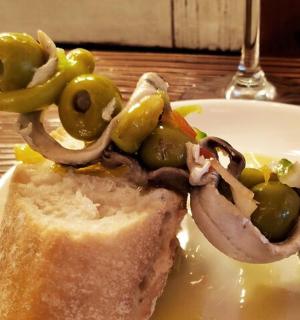a plate of food with a sandwich on a table