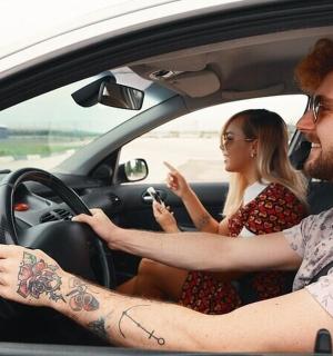 a man and a woman sitting in a car