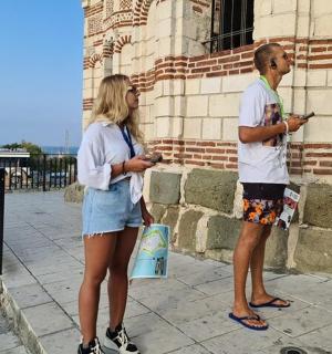 a man and a woman looking at their cell phones