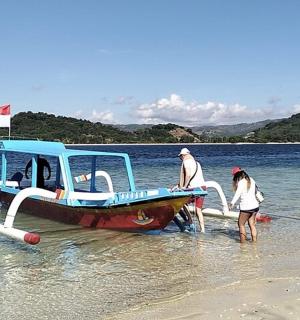 a group of people standing on a boat in the water