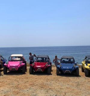 a group of four four wheelers parked on the beach
