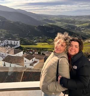 a man and a woman standing on top of a mountain