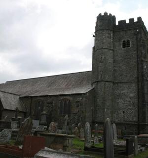 an old church with a cemetery in front of it