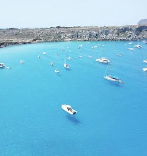 an aerial view of boats in a large body of water