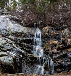 a waterfall on top of a pile of rocks