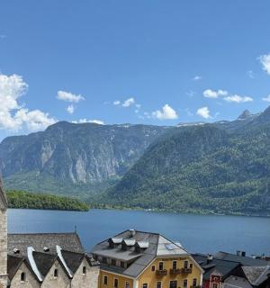 a church next to a lake with mountains in the background