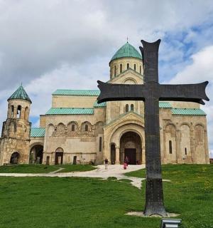 a large church with a cross in front of it