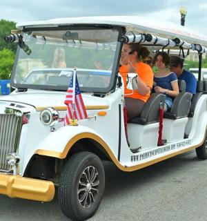 a group of people riding in a golf cart