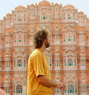 a man standing in front of a large building