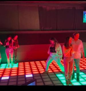 a group of people standing in a room with lights