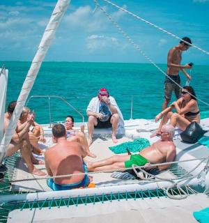 a group of people sitting on a boat in the water