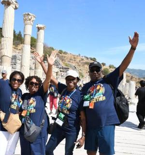 a group of people standing in front of the ruins