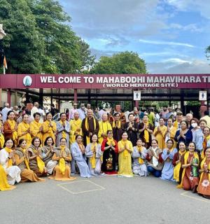 a group of people posing for a picture in front of a building
