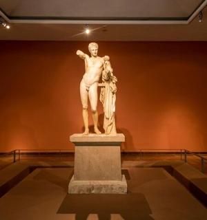 a statue of a man on a pedestal in a museum