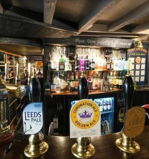 a bar with a counter with a lot of alcohol