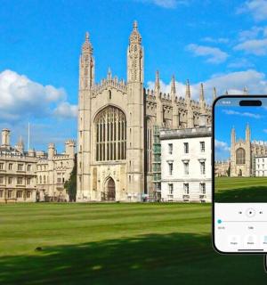 two cell phones in front of a large building