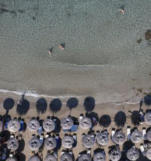an aerial view of a beach with a group of umbrellas
