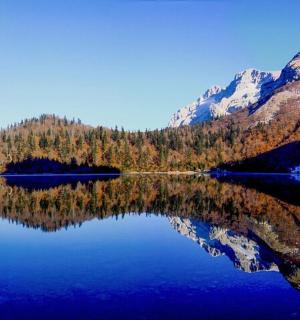 a reflection of a mountain in a lake