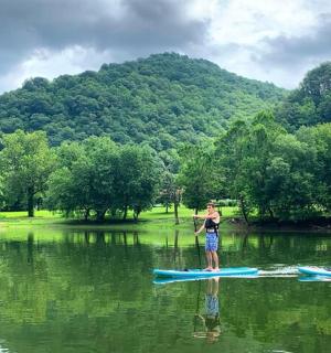 two people are standing on paddle boards in the water