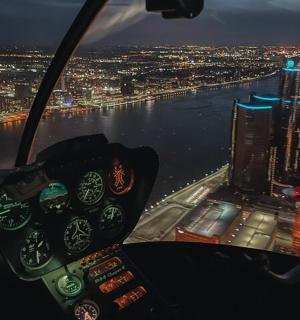 a view of a helicopter flying over a city