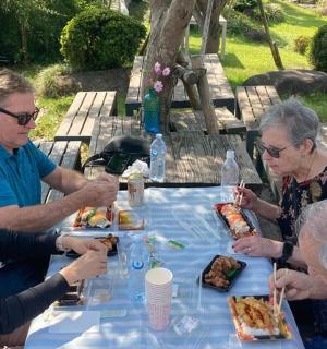 a group of people sitting at a table eating food