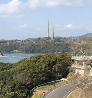 a road next to a river with a bridge