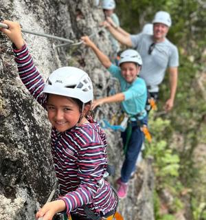 a group of people climbing on a rock wall