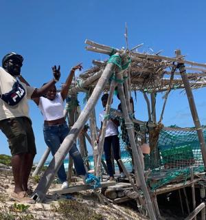 a group of people standing on top of a boat