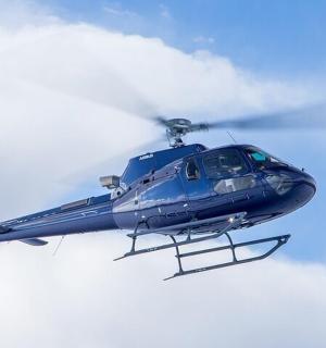 modrý vrtulník letí na obloze