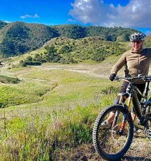 a man riding a bike on a hill