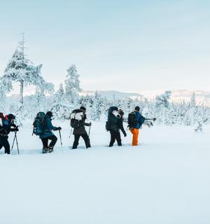 a group of people walking in the snow
