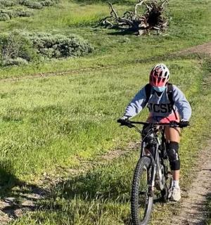 a person riding a bike on a dirt road
