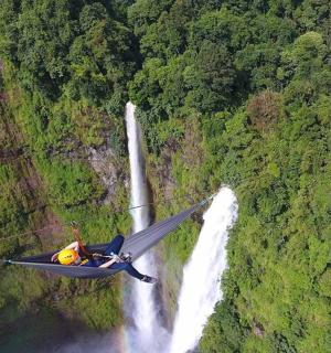 an airplane is flying over a waterfall