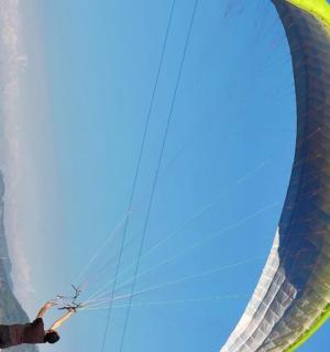 一名男子正抓着一只巨大的绿色风筝