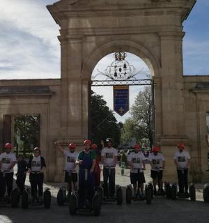 a group of people on segways in front of a building