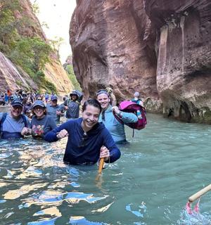 a group of people in the water in a river