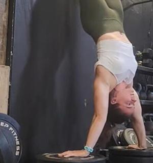 一名女子在重物上做倒立