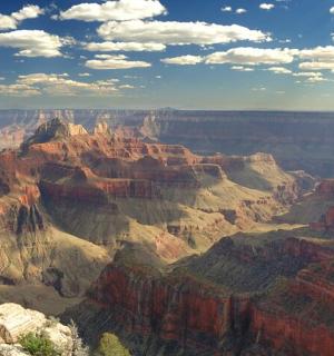 a view of the grand canyon under a cloudy sky