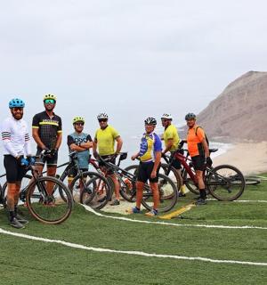 一群骑自行车的人站在山上的一排