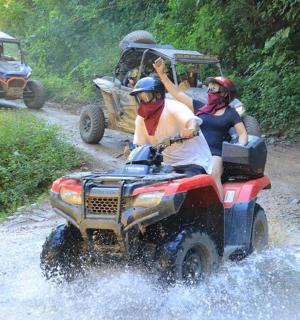 a group of people riding on a four wheeler in the water