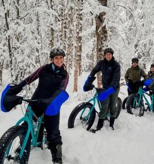 a group of people on bikes in the snow
