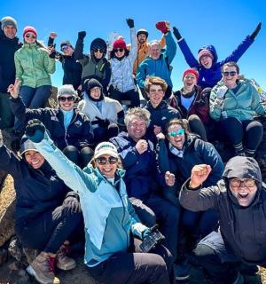 a group of people posing for a picture on some rocks