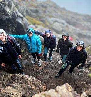 a group of people walking on a rocky mountain